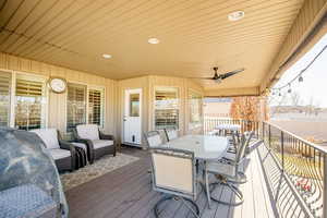 Wooden deck with ceiling fan and an outdoor hangout area