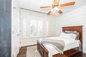 Bedroom with dark wood-type flooring and ceiling fan