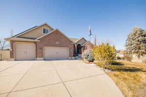 View of front facade featuring a garage and a front yard