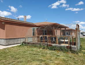 Rear view of property featuring a lawn