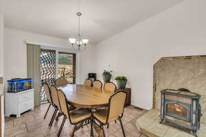 Tiled dining room featuring a notable chandelier