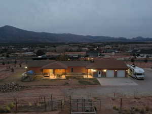 Rear view of property featuring a garage and a mountain view