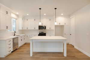 Kitchen with a sink, appliances with stainless steel finishes, tasteful backsplash, and recessed lighting