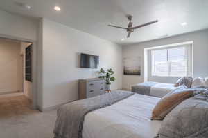 Bedroom featuring ceiling fan and light carpet