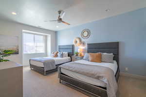 Bedroom featuring ceiling fan and light colored carpet