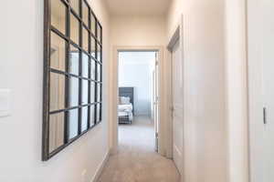 Hallway with light colored carpet