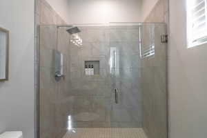 Bathroom with a shower with door