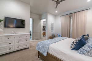 Carpeted bedroom featuring ceiling fan