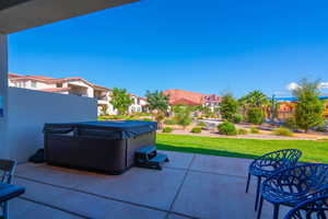 View of patio / terrace featuring a hot tub and a mountain view