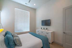 Bedroom featuring light carpet and ceiling fan