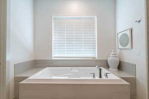 Bathroom featuring a relaxing tiled tub