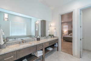 Bathroom with ceiling fan, tile patterned floors, and vanity