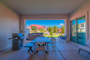 View of patio / terrace featuring a grill, a mountain view, and a hot tub