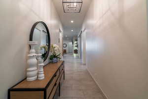 Corridor featuring light tile patterned floors and a barn door