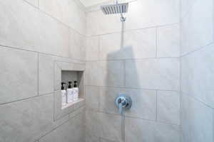 Room details featuring a tile shower