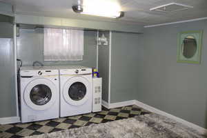 Laundry area with washer and clothes dryer