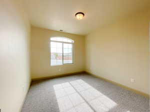 Spare room featuring light carpet