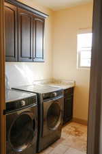 Laundry room with cabinets and independent washer and dryer