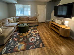 Living room with hardwood / wood-style floors and a textured ceiling