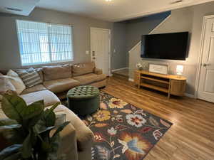 Living room with hardwood / wood-style flooring and a textured ceiling