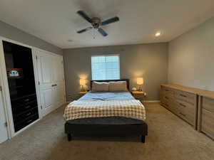 This master bedroom is a spacious retreat featuring 2 built in, lighted, closets with built in organizers with a built in shelf and dresser in the middle.