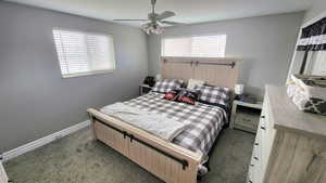 Carpeted bedroom featuring ceiling fan