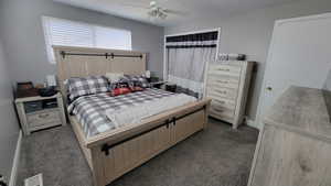 Bedroom with dark carpet and ceiling fan