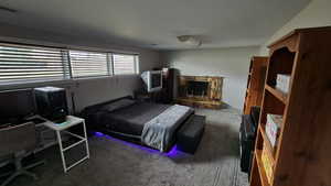 Carpeted bedroom with a fireplace