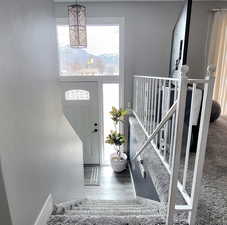 Foyer with wood-type flooring and a mountain view