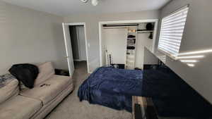 Carpeted bedroom featuring a closet