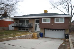 View of front of house featuring a garage and a front yard