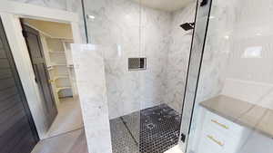 Bathroom featuring tiled shower