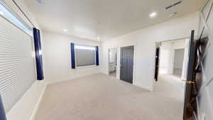 Unfurnished bedroom with light carpet