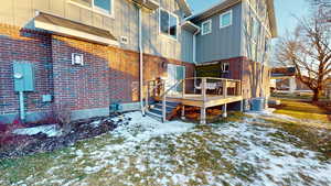 Back of property featuring a deck and central air condition unit