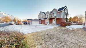 View of front facade with a garage and a mountain view