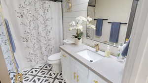 Bathroom with vanity, tile patterned flooring, and toilet