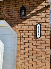 Downstairs apartment address on south edge of garage by entrance sidewalk.