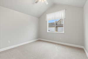 Bonus room with vaulted ceiling, carpet floors, and ceiling fan