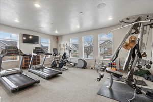 Workout area featuring a textured ceiling