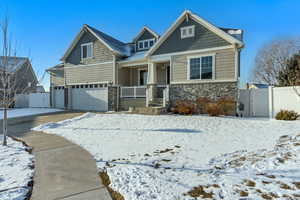 Craftsman-style home featuring a garage and covered porch