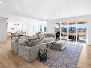 Living room with a textured ceiling and light wood-type flooring