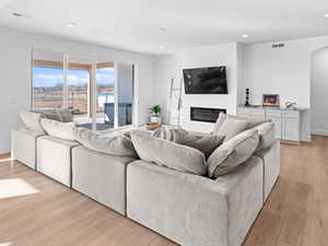 Living room with a textured ceiling and light wood-type flooring