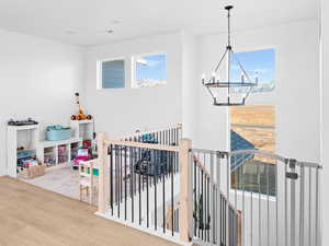 Playroom featuring hardwood / wood-style flooring and a notable chandelier