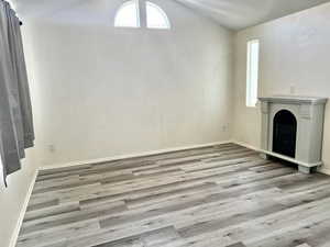 Living room with lofted ceiling and light wood-type flooring