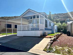 View of front of property with a mountain view, and covered porch