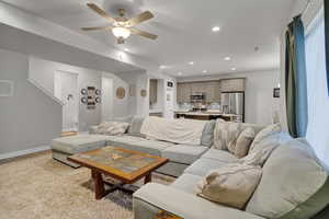 Living room featuring ceiling fan and light hardwood / wood-style floors