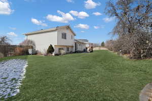 View of side of property with a lawn