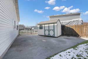 View of patio featuring a shed