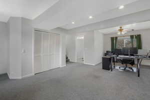 Office area with ceiling fan and carpet flooring