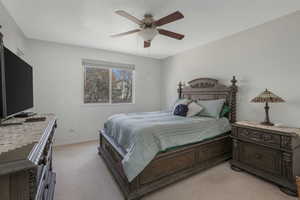 Bedroom with light colored carpet and ceiling fan